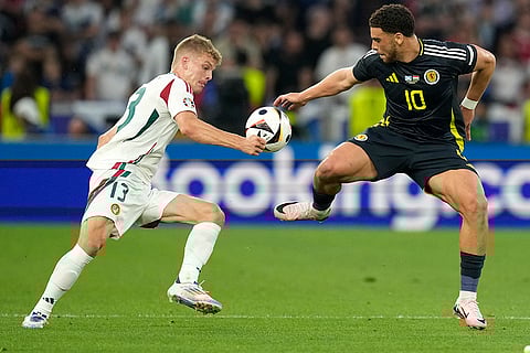 Andras Schafer and Che Adams vie for the ball